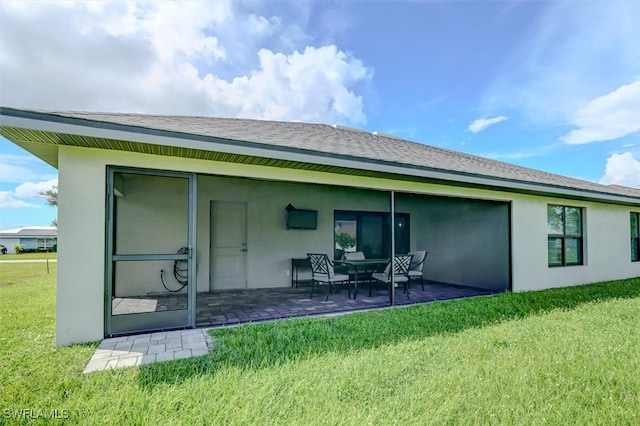 rear view of house with a patio area and a yard