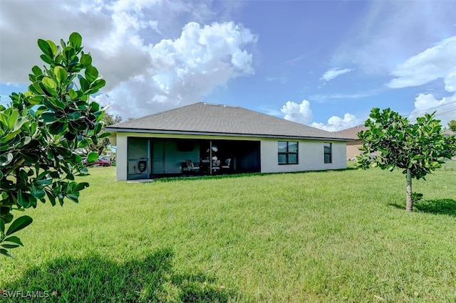 rear view of house with a yard