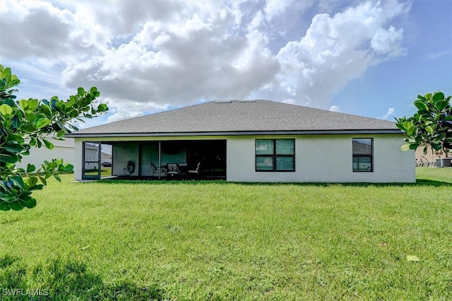 rear view of house featuring cooling unit and a yard