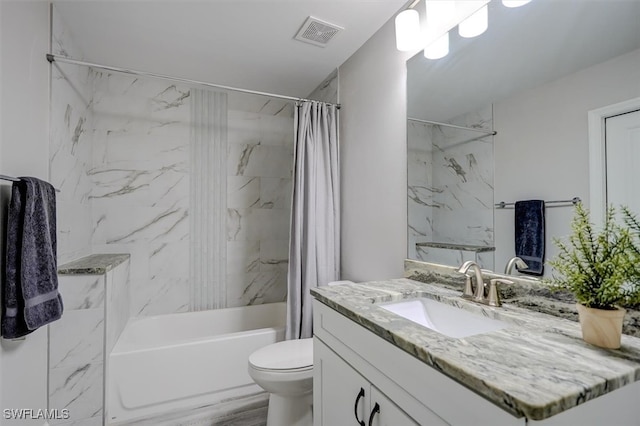 full bathroom featuring shower / tub combo, vanity, and toilet