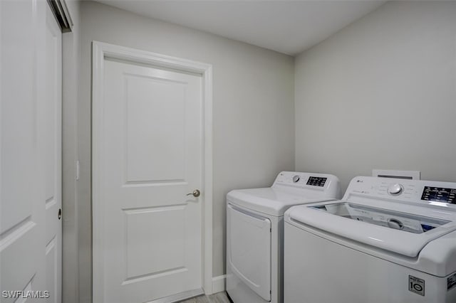 clothes washing area with independent washer and dryer