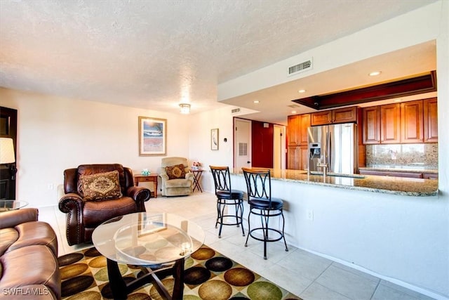 4906 Victoria Dr Unit 413, Cape Coral, FL 33904 - living area featuring light tile patterned flooring and a textured ceiling