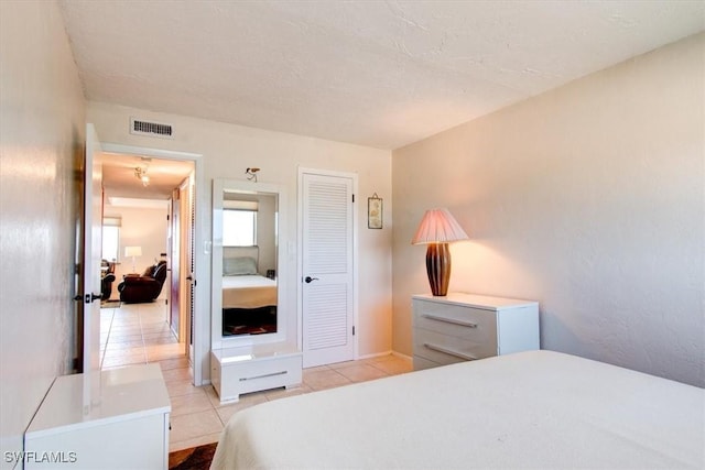 4906 Victoria Dr Unit 413, Cape Coral, FL 33904 - bedroom with light tile patterned flooring and a closet