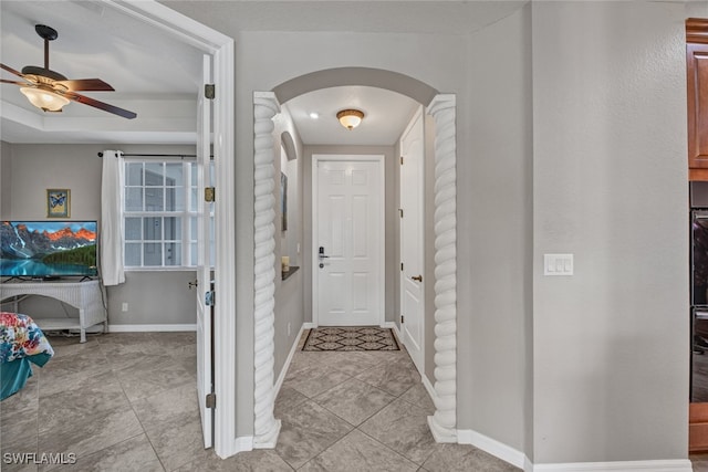 foyer featuring ceiling fan and light tile patterned floors