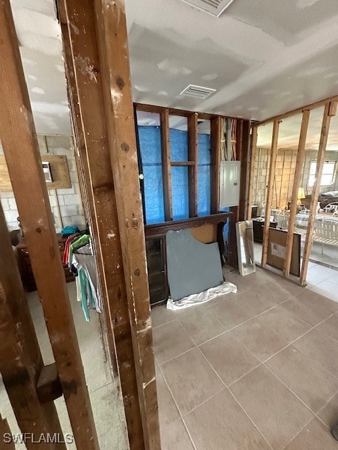 bathroom with electric panel and tile patterned flooring