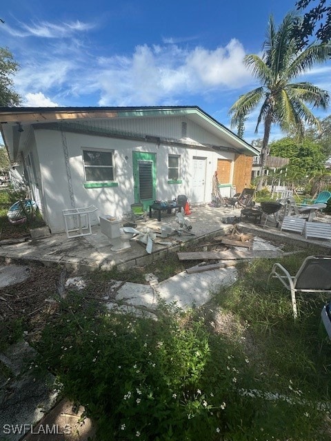 back of house with a patio