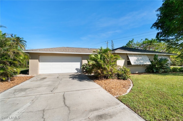 ranch-style home with a front lawn and a garage