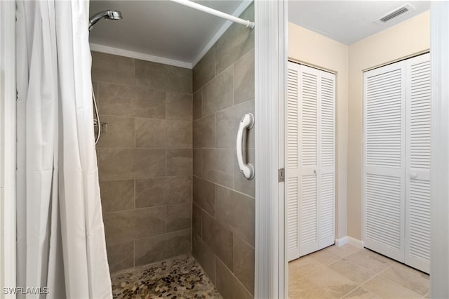 bathroom with a shower with shower curtain and ornamental molding