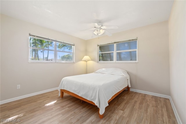 bedroom featuring hardwood / wood-style flooring and ceiling fan