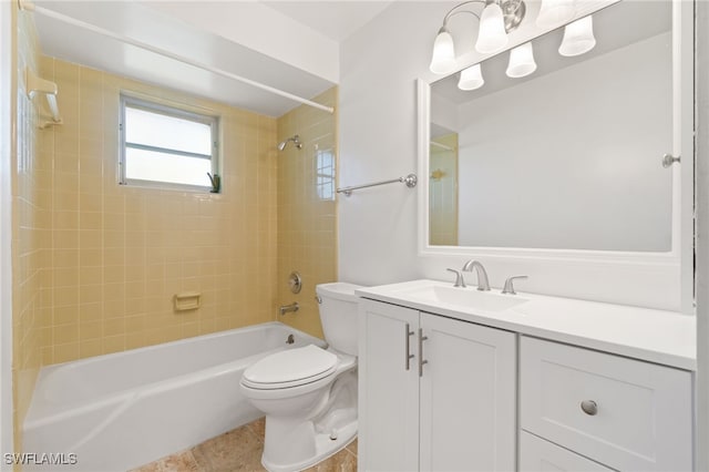 full bathroom with tile patterned flooring, vanity, tiled shower / bath combo, and toilet