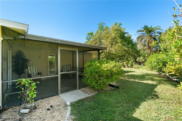 view of yard featuring a sunroom