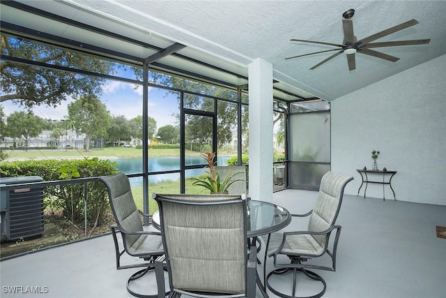 sunroom with a water view and ceiling fan