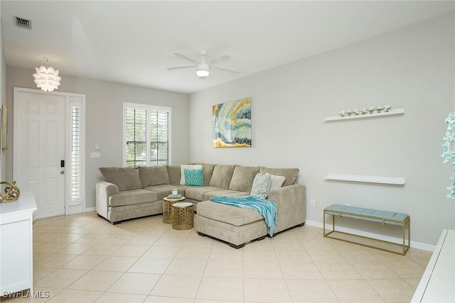living room with light tile patterned floors, a ceiling fan, visible vents, and baseboards