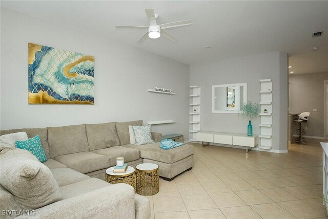 living room featuring light tile patterned floors and ceiling fan