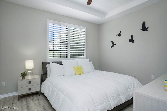 bedroom with ceiling fan and light hardwood / wood-style floors