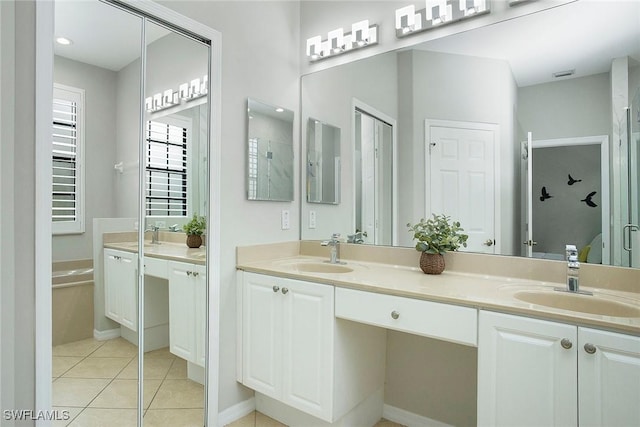 bathroom with vanity, a bath, and tile patterned floors