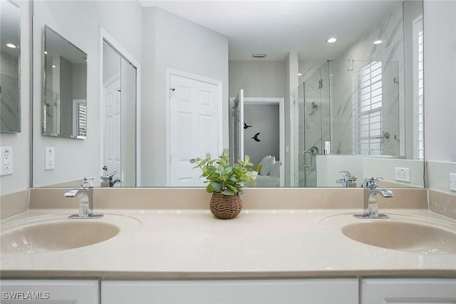 bathroom with vanity and a shower with shower door