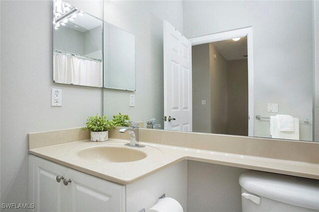 bathroom featuring vanity and toilet