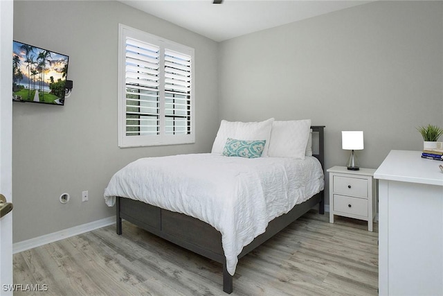 bedroom featuring baseboards and light wood-type flooring
