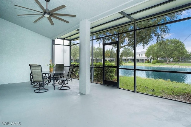 sunroom / solarium featuring outdoor dining space, a water view, and ceiling fan