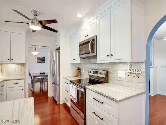 kitchen featuring appliances with stainless steel finishes, dark hardwood / wood-style flooring, and white cabinets