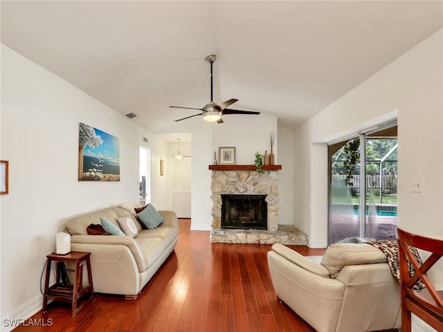 living room with wood-type flooring, lofted ceiling, ceiling fan, and a fireplace