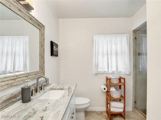 bathroom featuring walk in shower, a healthy amount of sunlight, vanity, and toilet