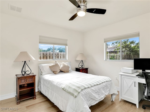 bedroom with light wood-type flooring and ceiling fan