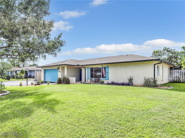 single story home featuring a garage and a front lawn