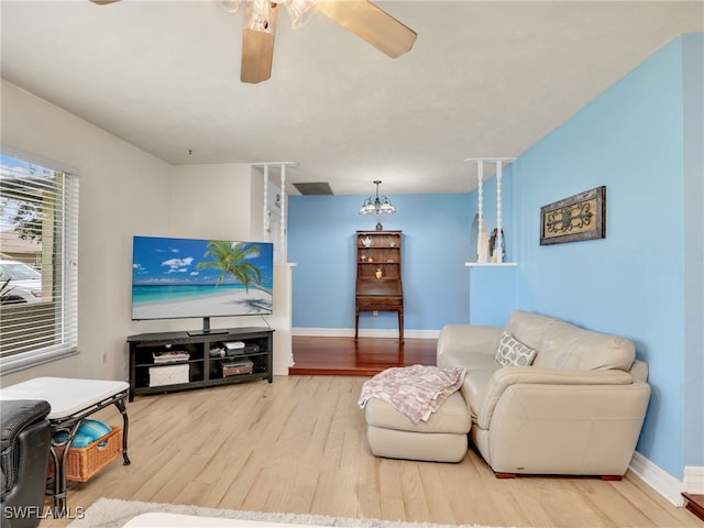 living room featuring ceiling fan and hardwood / wood-style floors