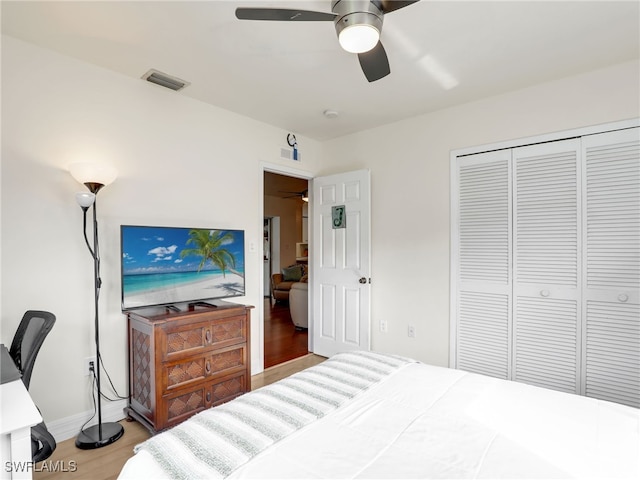 bedroom with a closet, ceiling fan, and hardwood / wood-style flooring