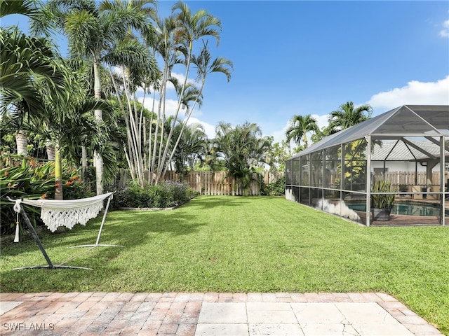 view of yard with a lanai and a fenced in pool