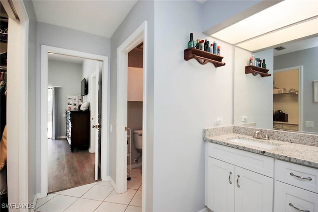 bathroom with vanity, hardwood / wood-style floors, and toilet