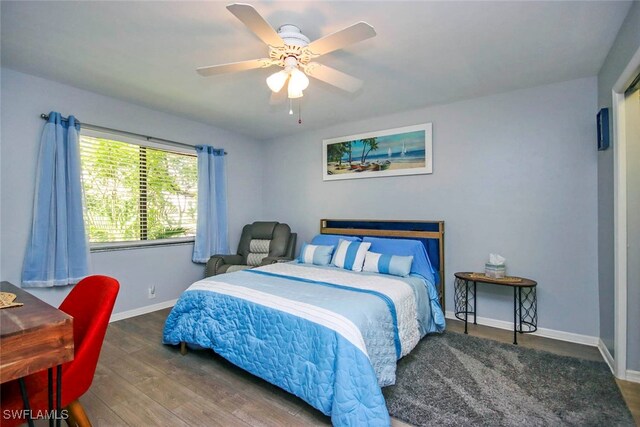 bedroom featuring dark hardwood / wood-style flooring and ceiling fan