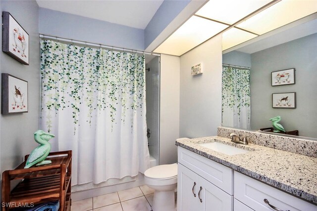 full bathroom with vanity, toilet, tile patterned floors, and shower / tub combo with curtain