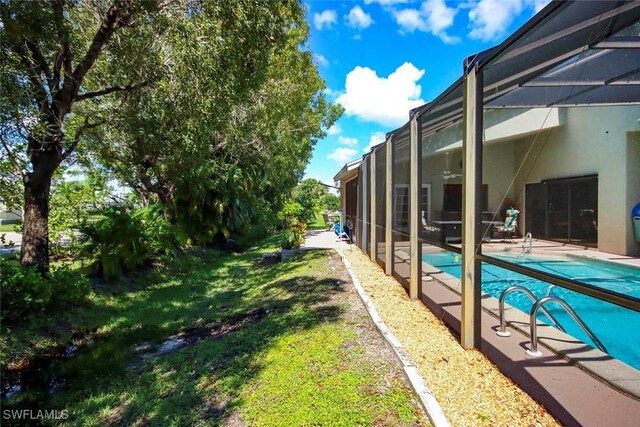 exterior space featuring a patio and glass enclosure