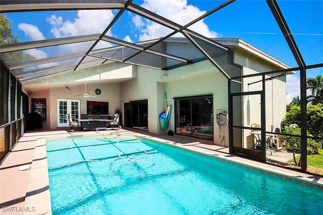 view of pool with ceiling fan, a patio area, and a lanai