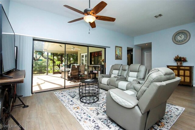 living room featuring wood-type flooring and ceiling fan