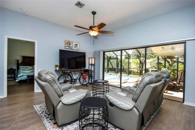 living room with hardwood / wood-style flooring and ceiling fan