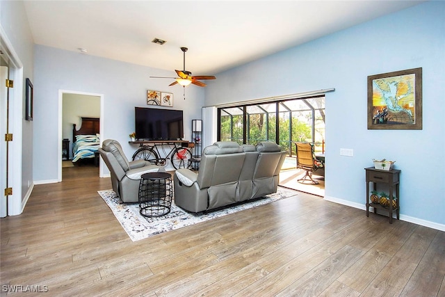 living room with light hardwood / wood-style floors and ceiling fan