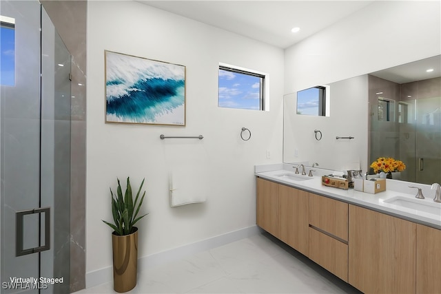 bathroom with vanity and a shower with door