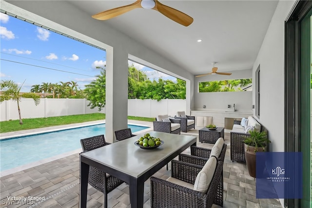 view of patio with an outdoor hangout area, a fenced in pool, and ceiling fan