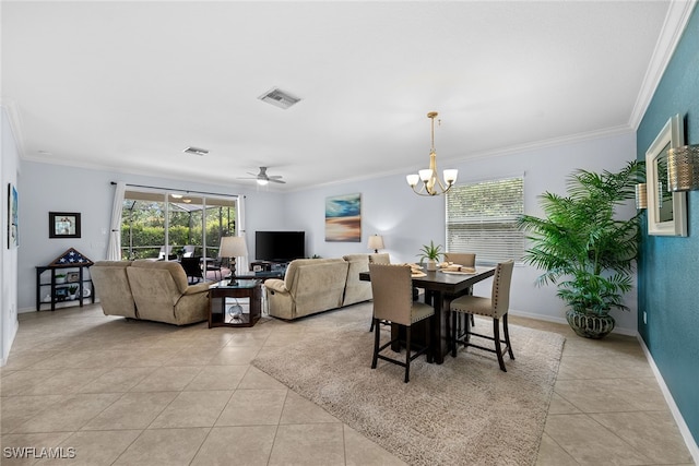 dining area with light tile patterned floors, ceiling fan with notable chandelier, and crown molding