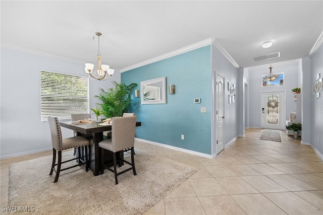 dining area with a chandelier, ornamental molding, and light tile patterned flooring