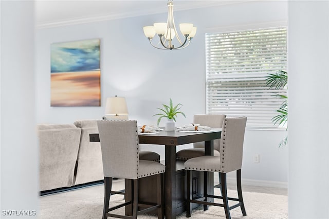 dining area with ornamental molding and a chandelier