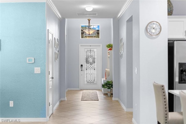 tiled entryway featuring ornamental molding