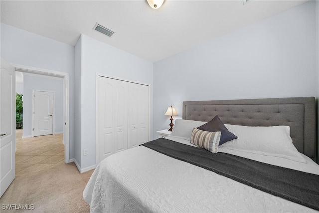 bedroom with light colored carpet and a closet