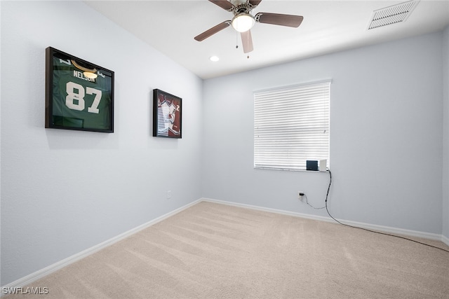 carpeted spare room with ceiling fan