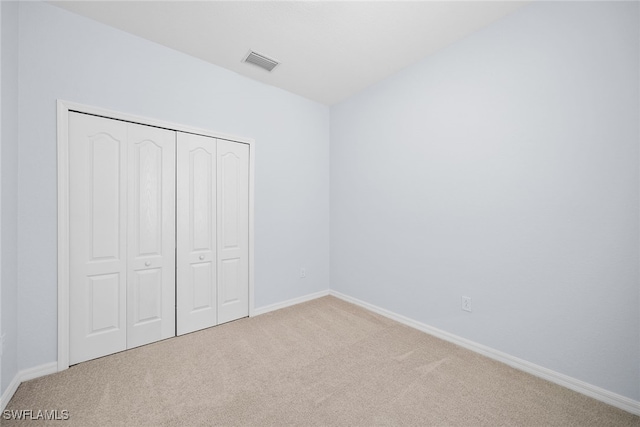 unfurnished bedroom with a closet and carpet floors