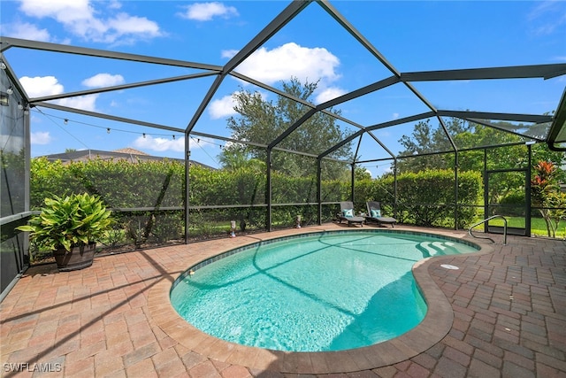 view of pool featuring a lanai and a patio area